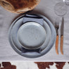 Handmade blue speckle bread plate and side plates by Palinopsia ceramics on a dinner table as part of a 3 piece dinner ware set
