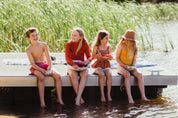 Kids on a lake eating a fruit salad out of Palinopsia ceramics and breakfast bowls