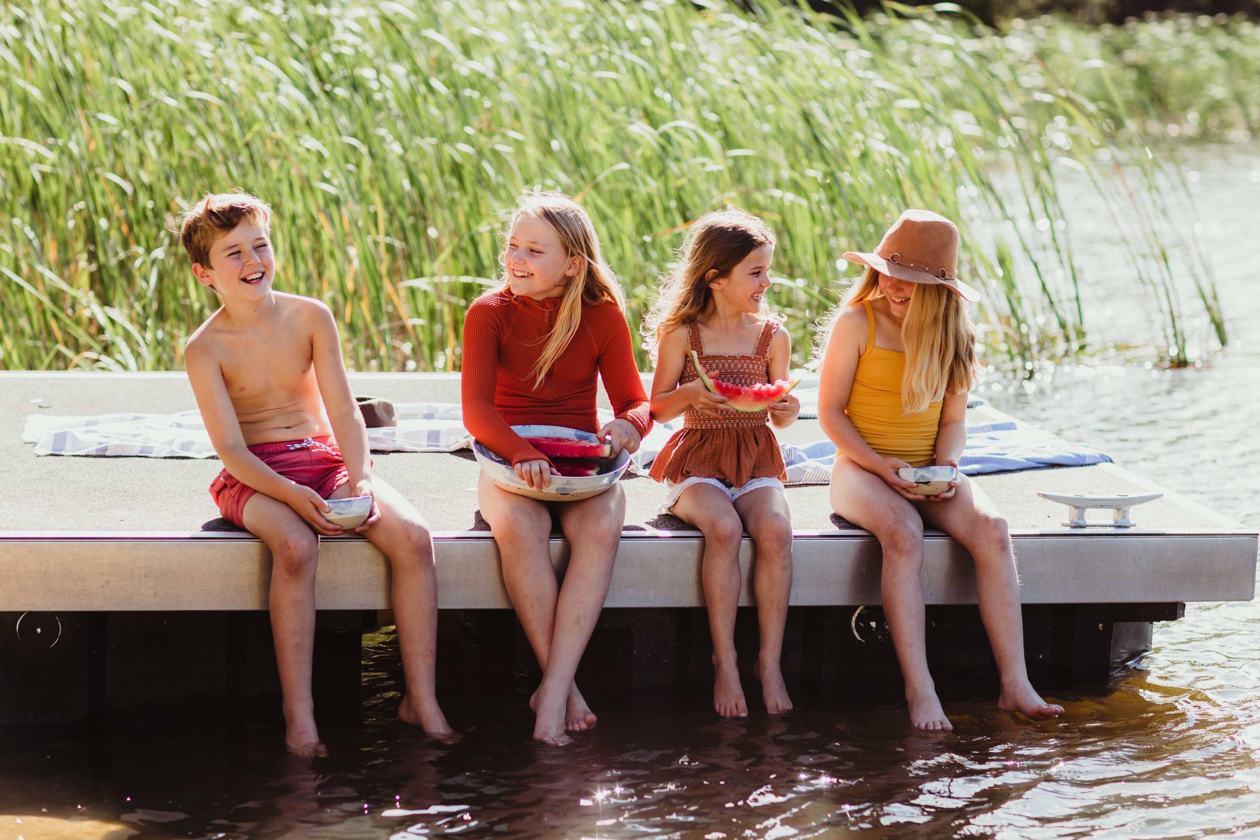 Kids on a lake eating a fruit salad out of Palinopsia ceramics and breakfast bowls