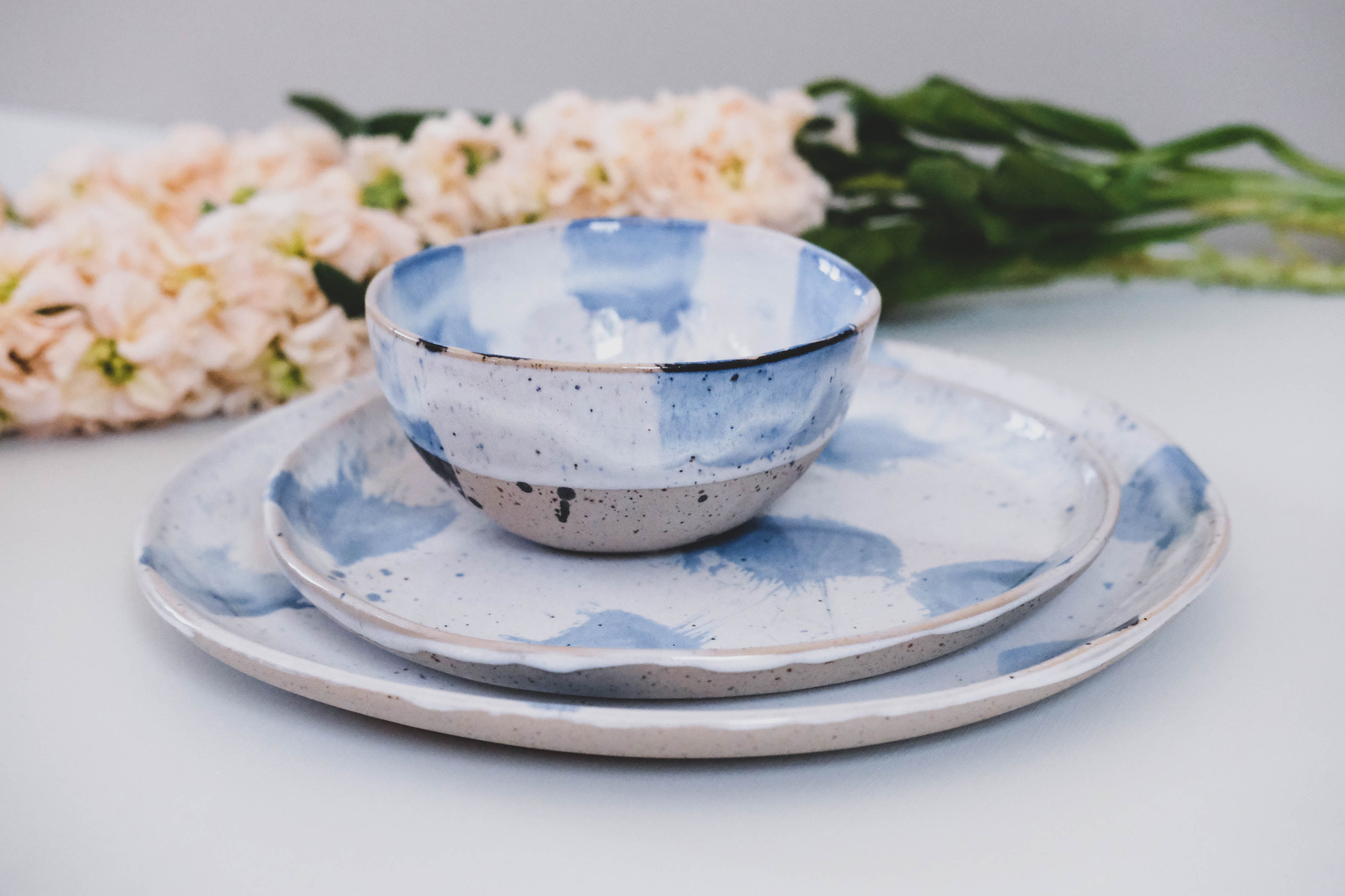 Three piece Pollock blue and white dinner set by Palinopsia Ceramics styled with wild flowers
