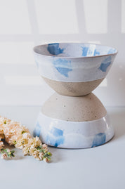 Two Pollock blue and white handmade fruit bowls stacked with wild flowers