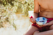 Boy holds a summer fruit salad served in Palinopsia Ceramics Pollock breakfast bowl by the lake in Sydney