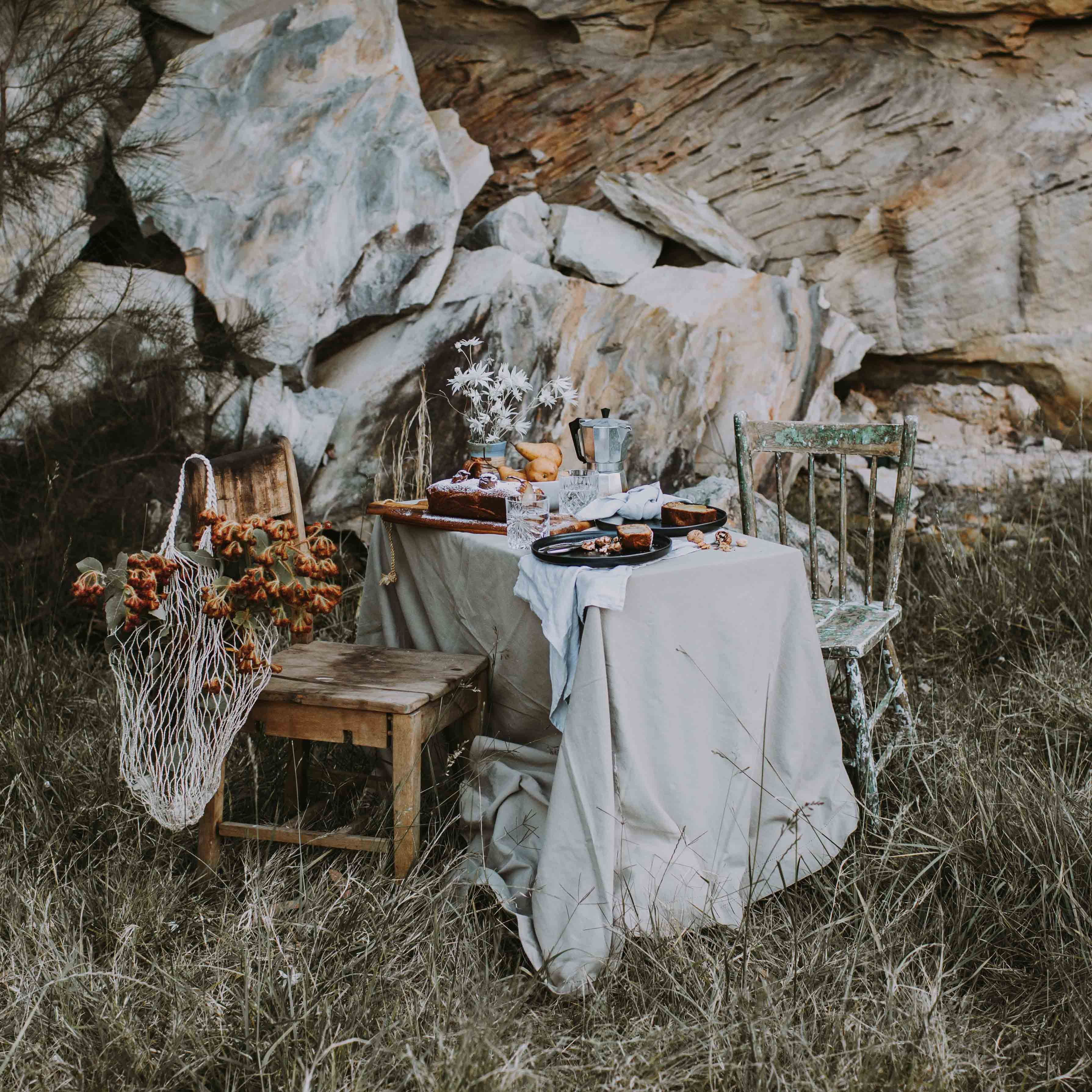 Australian outdoor dining with native wild flowers, homemade gluten free cake and Palinopsia ceramics handmade Sabe dinner set in black, grey and blue