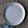 Bird's-eye view of a Blue lunch plate on grey linen by Palinopsia Ceramics 