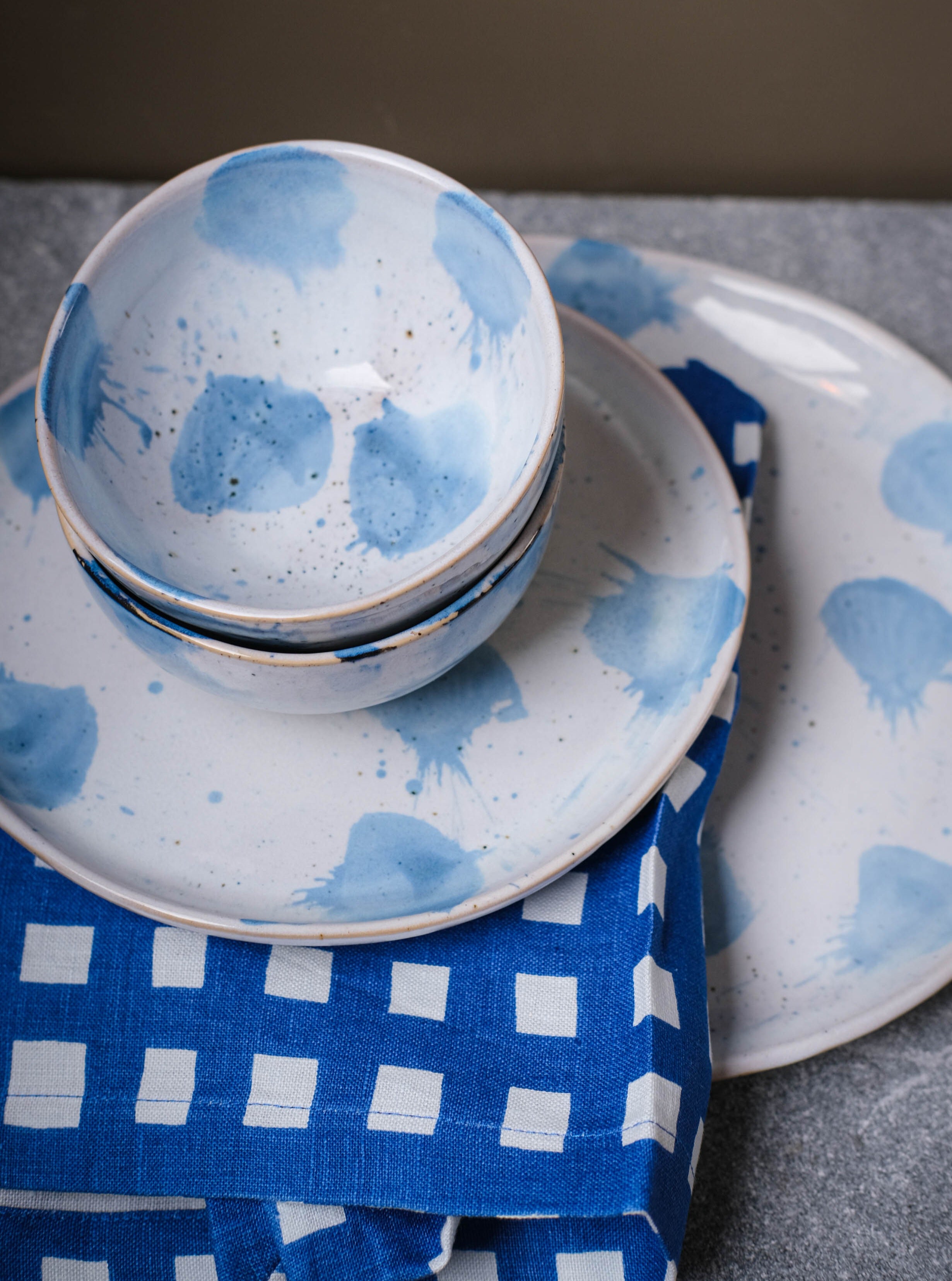 Handmade and hand painted abstract dinner set by Palinopsia Ceramics in blue and white drippy glaze