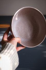 Hand holding a handmade stoneware breakfast bowl in mushroom glaze by Palinopsia Ceramics Sydney