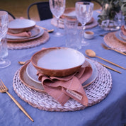 Outdoor table setting with vintage inspired dinnerware in blues and browns, dinner plate, lunch plate and soup bowl