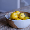 Detailed shot of a handmade ceramic rustic vintage inspired fruit bowl in browns and blue glaze 