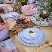 Three piece dinnerware set in blue stoneware by palinopsia ceramics on a yellow mustard linen tablecloth
