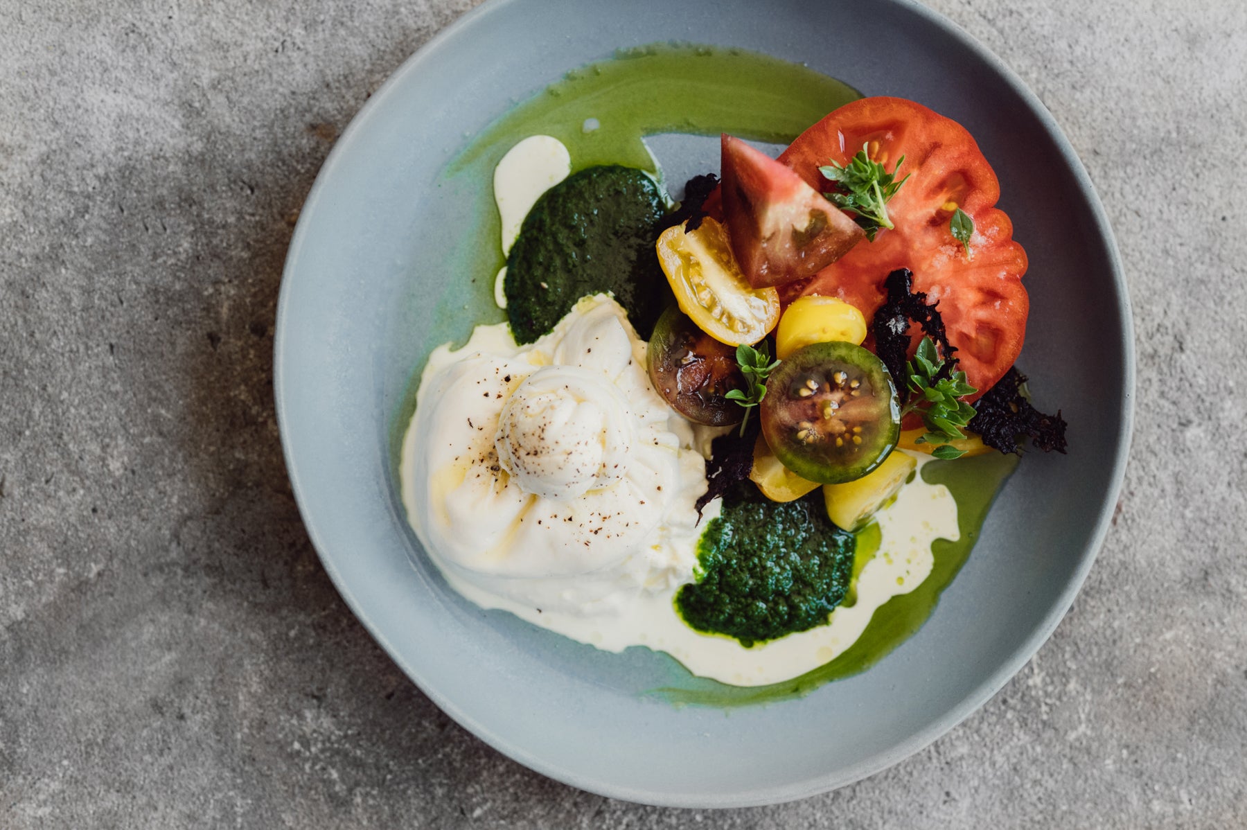 bird's-eye view of a Caprese Salad in a blue handmade bowl by Palinopsia Ceramics in Sydney Australia