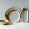 4 piece dinner set staged by Palinopsia Ceramics on a white tablecloth 