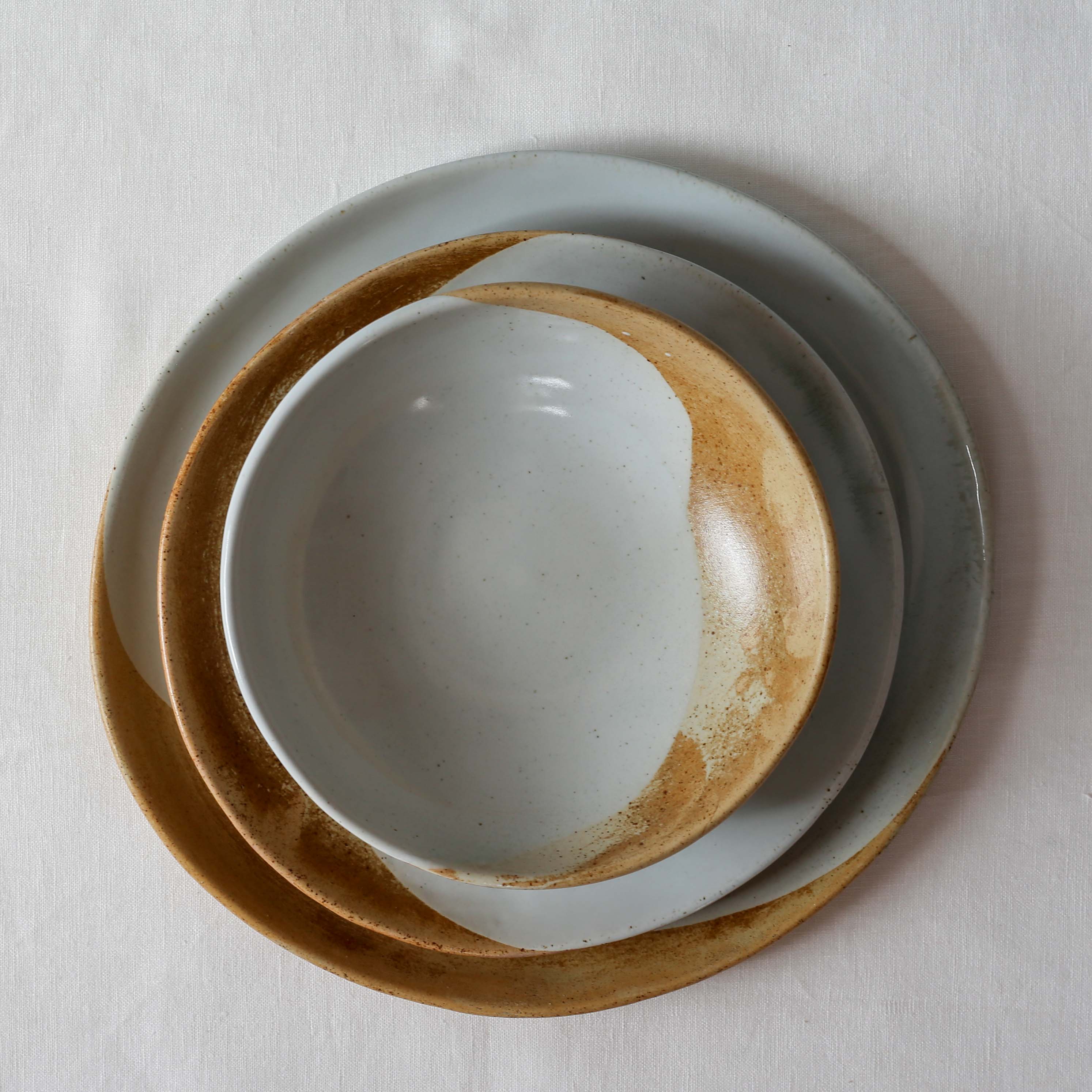 Bird's-eye view of a three (3) piece Soda fired dinner set in brown, grey and blue
