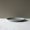 Side view of a handmade lunch plate on a white tablecloth 