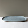 Side view of a large rectangle serving platter in blue grey with speckles by Palinopsia Ceramics 
