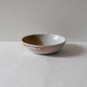 Side view of a colourful pink and brown breakfast bowl  