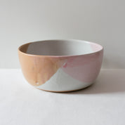 Sideview of Palinopsia Ceramics handmade serving bowl in pink, chocolate and white showing melting glaze details
