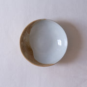 Bird's-eye view of Palinopsia Ceramics breakfast bowl on a white tablecloth