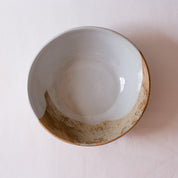 Bird's-eye view of a salad bowl in retro colours of brown, blue and greys