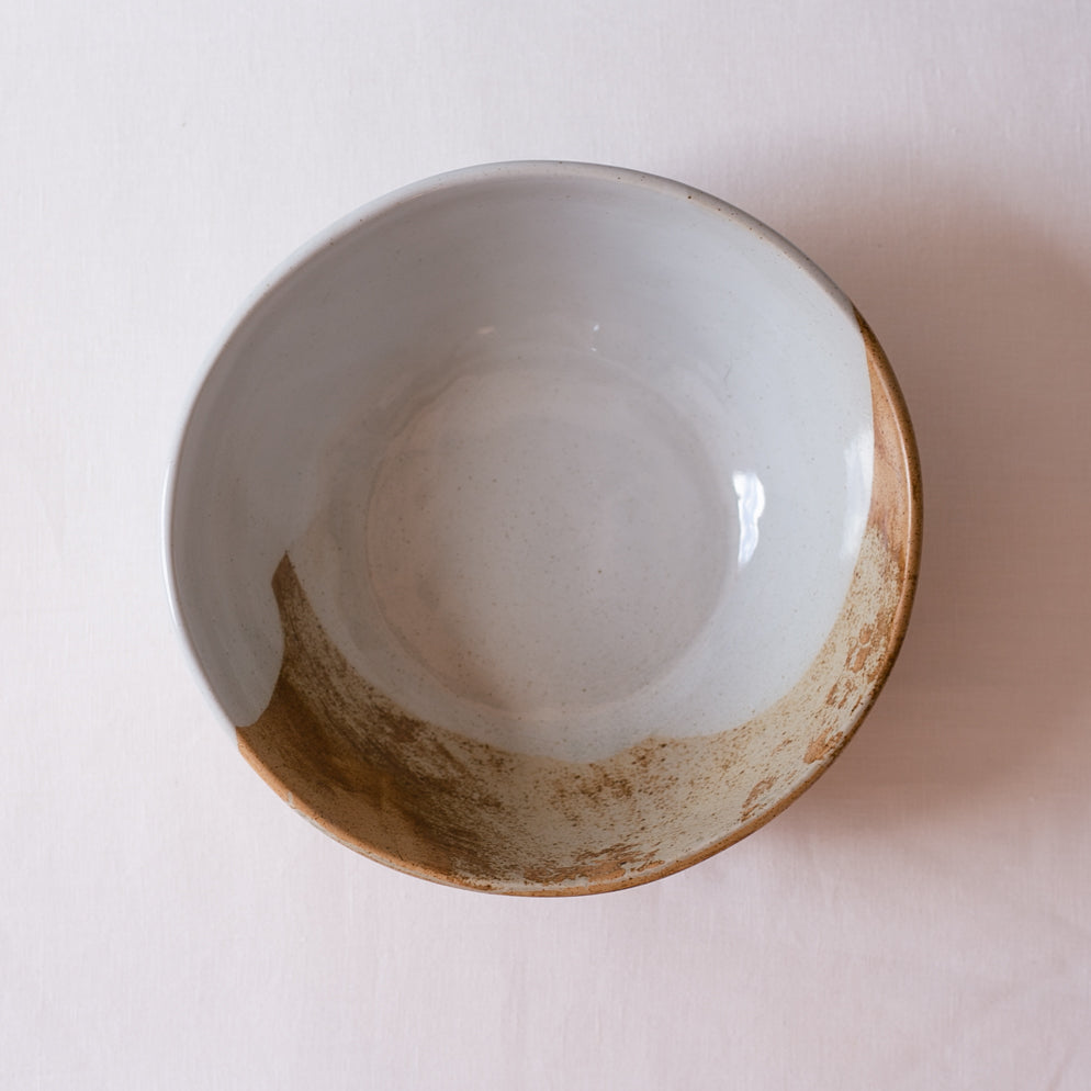 Bird's-eye view of a salad bowl in retro colours of brown, blue and greys