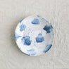 Bird's-eye view of abstract handmade dinner plate in blue and white by Palinopsia Ceramics 