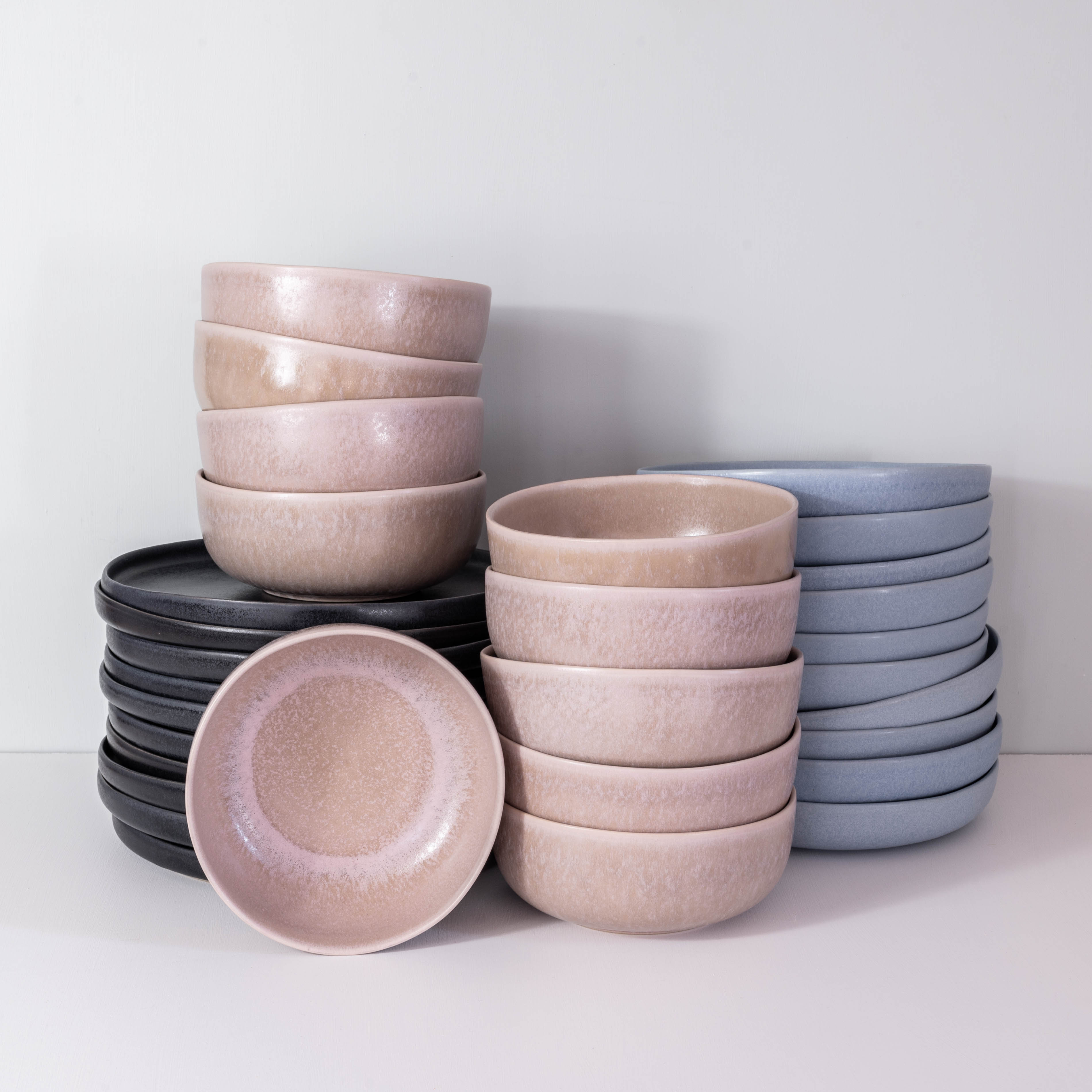 Large stack of handmade dinner set for 10 people by Palinopsia Ceramics in Sydney Australia