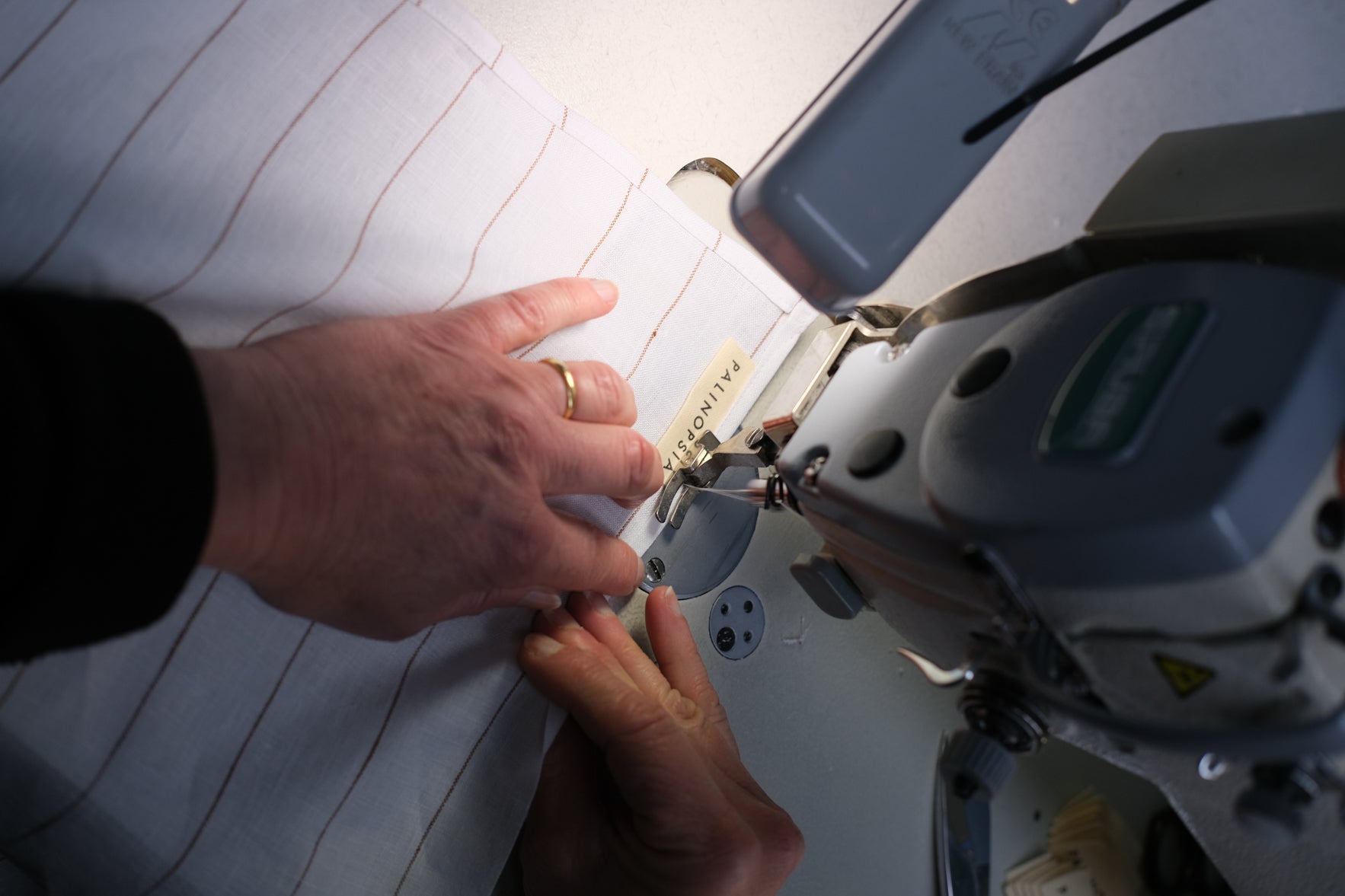 Sewing Palinopsia's Australian Made Linen Napkins and Tablecloths a close up of a sewing machine and sewer