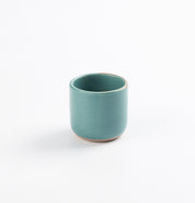 Antique teal blue green espresso cup on a white background 