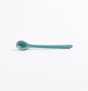 Antique teal blue and green teaspoon by Palinopsia Ceramics on a white background 