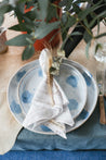 coastal table setting with blue and white plates and pinstripe table napkins by Palinopsia Ceramics 