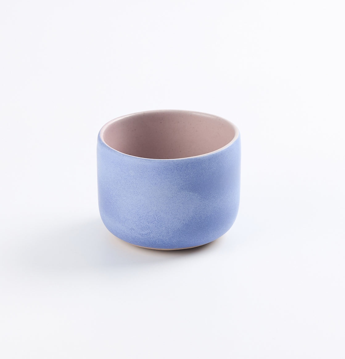 Baby blue and pink tumbler cup on white background