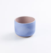 Baby blue and pink tumbler cup on white background