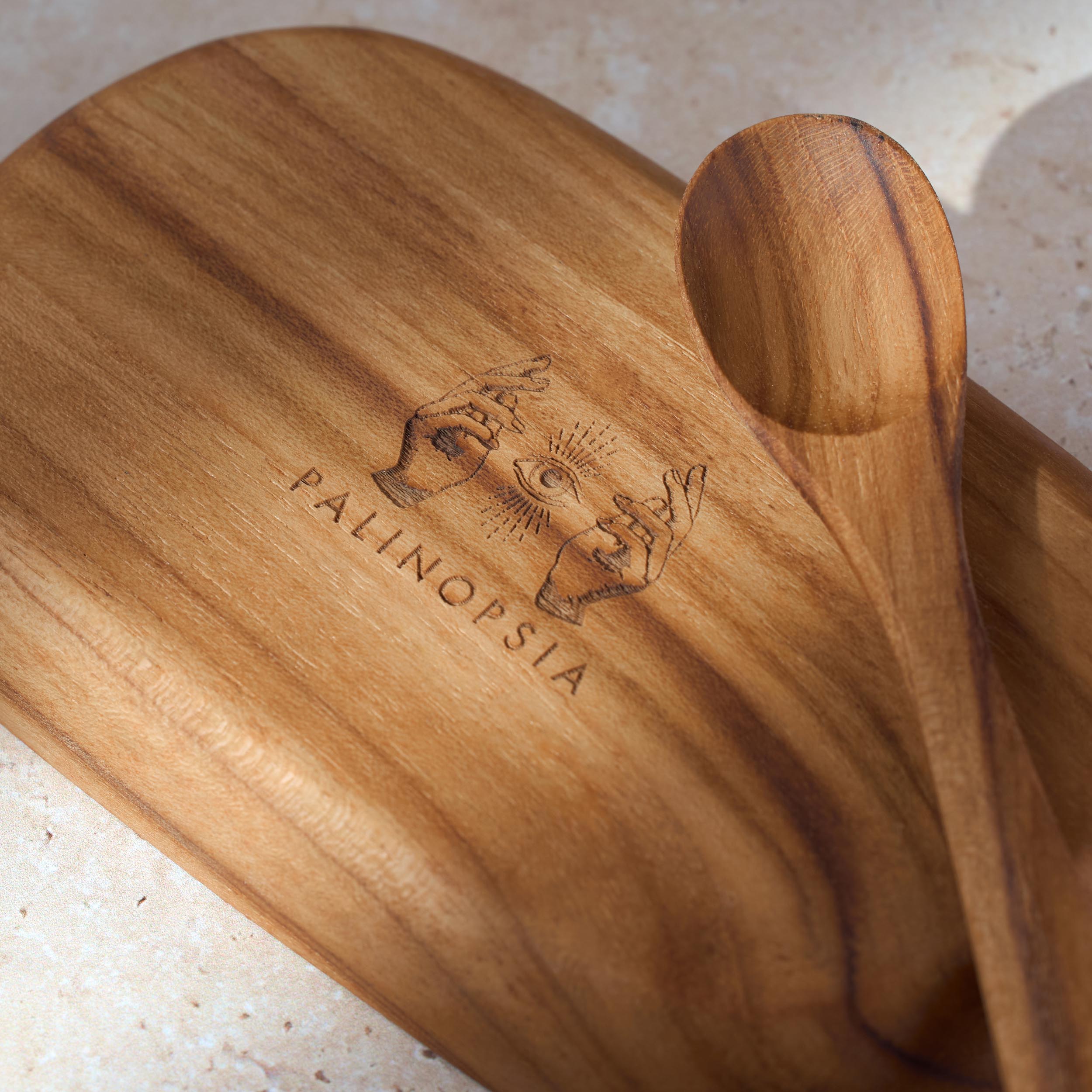 Wooden dish with 'Palinopsia' branding on a light background with teaspoon for serving