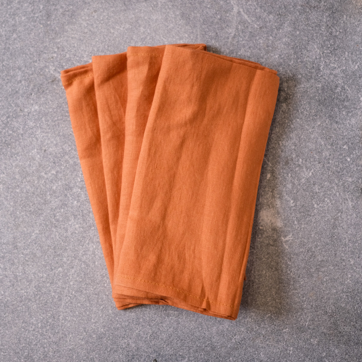 Four pack of Ginger coloured table napkins by Palinopsia Ceramics 