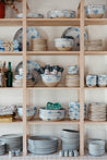 Stacked shelves with handmade ceramic dinner sets by Palinopsia Ceramics 