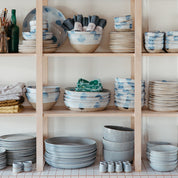 Stackled shelves full of handmade ceramics and table linen by Palinopsia Ceramics on Darby Street in Newcastle 