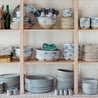 Stackled shelves full of handmade ceramics and table linen by Palinopsia Ceramics on Darby Street in Newcastle 