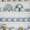 Stacked shelf with handmade ceramic mugs by Palinopsia Ceramics for tea and coffee
