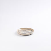 Small ceramic side bread plate with a marbled design on a white background