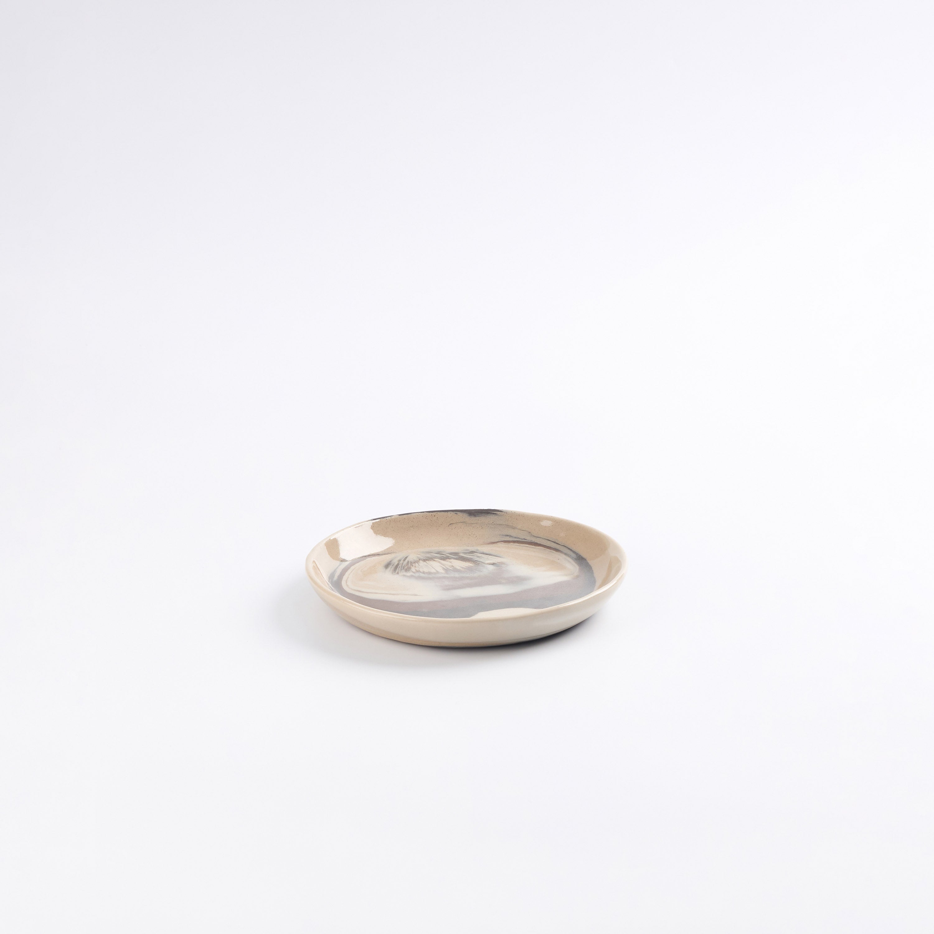 Small ceramic side bread plate with a marbled design on a white background