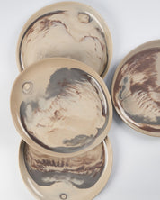 Set of ceramic plates with marbled design on a white background