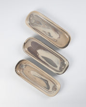 Three marbled clay ceramic oval trays on a white background