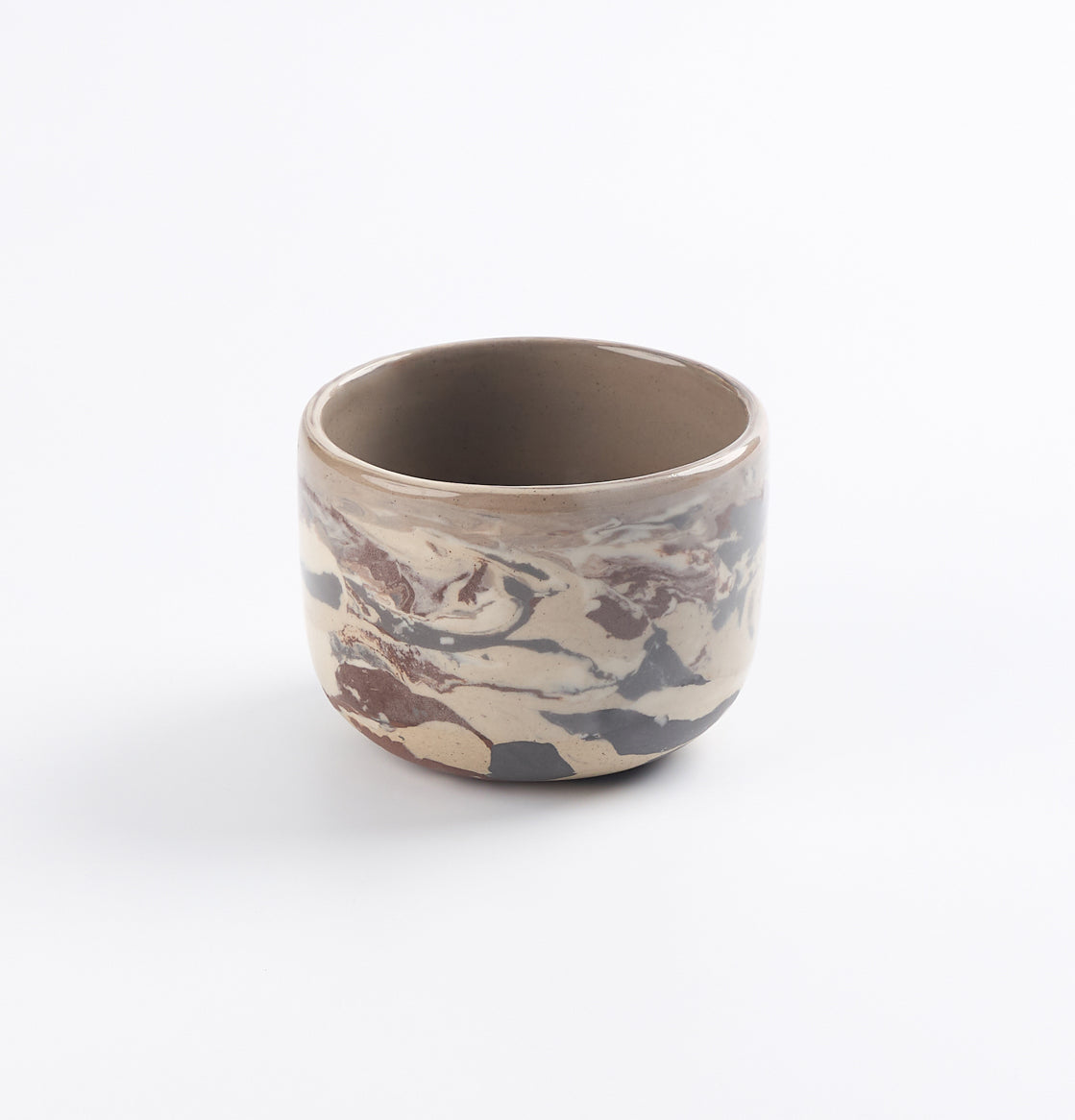 Ceramic cup with a 4 colour marbled clay design and a clear gloss on a white background