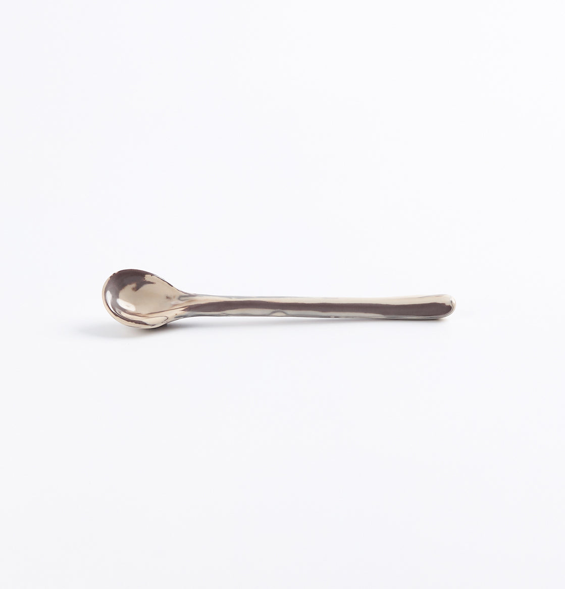 Ceramic teaspoon with a marbled clay design on a white background