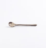 Ceramic teaspoon with a marbled clay design on a white background
