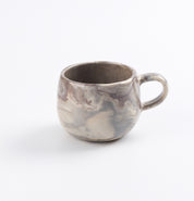 Four colour marbled ceramic mug on a white background by Palinopsia 