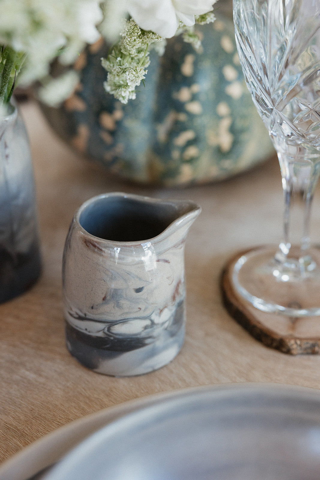 Small marble pitcher on dinner table 