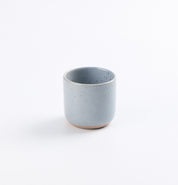 Blue ceramic espresso cup on a white background