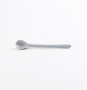 Ceramic spoon with speckles on a white background