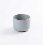 Light blue ceramic coffee cup on a white background