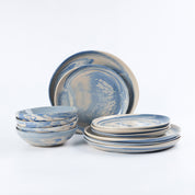 Three piece dinner set of handmade ceramics with a marbled clay pattern in cobalt blue, beige and cream on a white background by Palinopsia